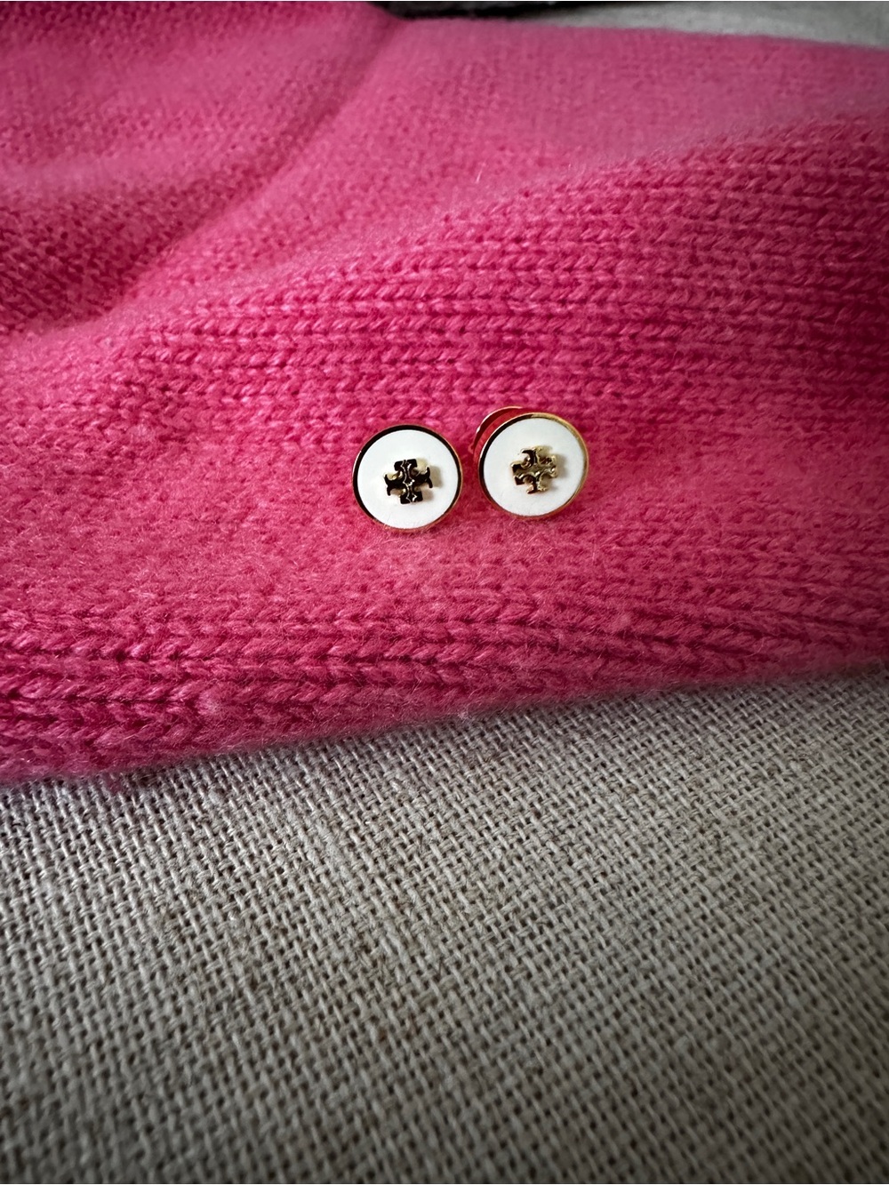 Gold & White Logo Button Stud Earrings on Pink Knit